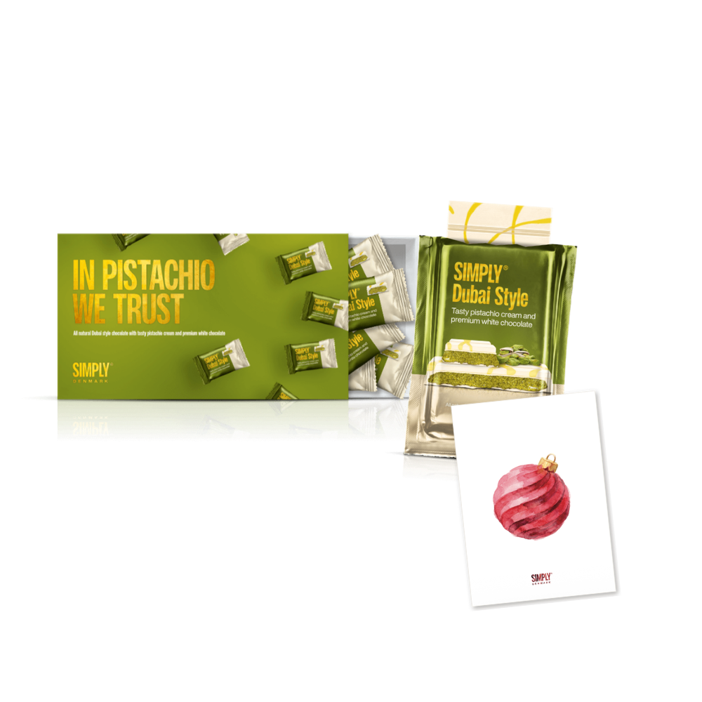 Pistachio Plus One: gaveæsken In Pistachio We Trust, en Sharing Bar med pistacie og hvid chokolade og et postkort
